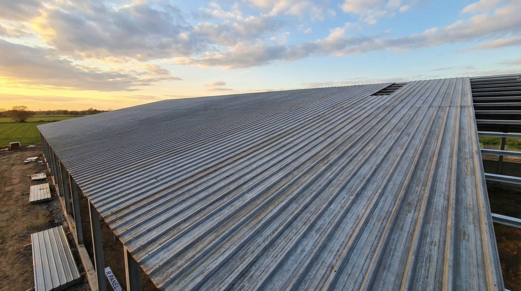 PBR Panel metal roofing system installed on a commercial building, showing exposed fasteners and ribbed steel panels similar to R Panel roofing